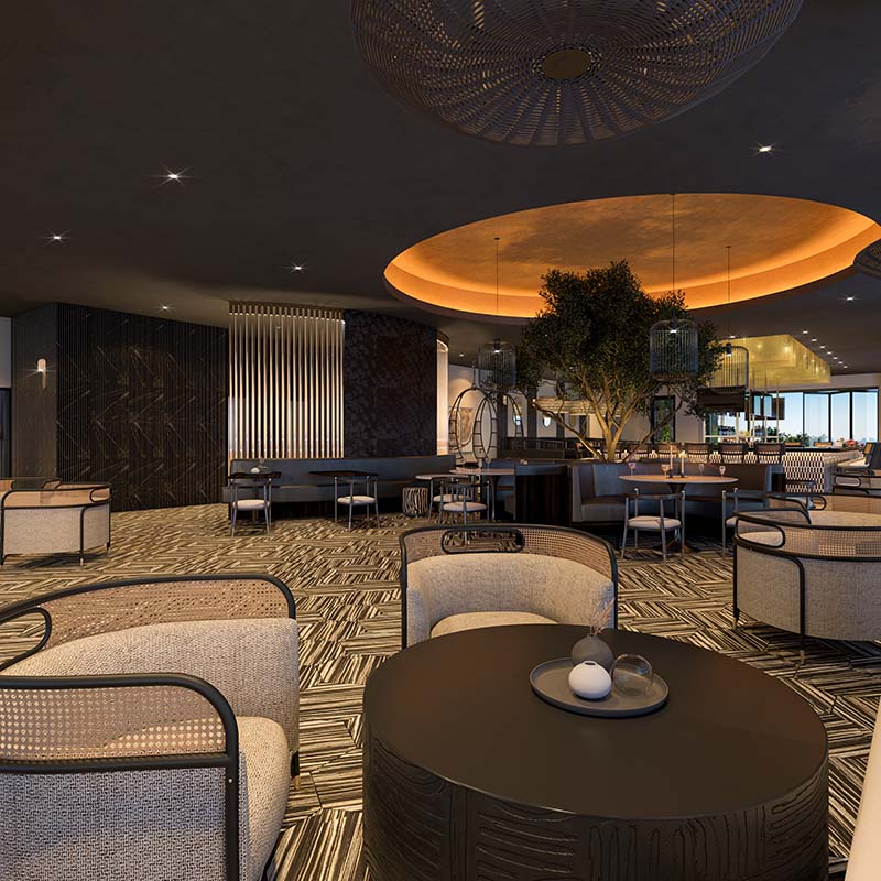 Spacious and stylish lounge area in a high-end restaurant with oversized circular ceiling lighting, modern furniture, and a central tree, showcasing luxurious interior design.