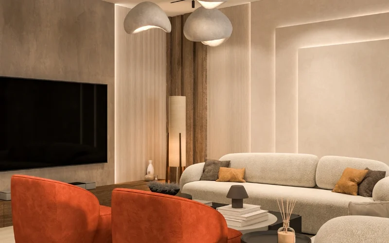 Studio Apartment Spacious and luxurious living room interior design with plush sofas and bold, red accent chairs, under elegant pendant lights, creating a vibrant yet sophisticated gathering space.